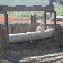 Large concrete pipe being supported 