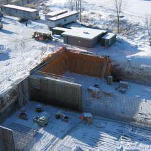 Winter foundation wall pours featuring rebar, formwork, heating and hoarding
