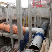 Process pipes installation beginning within building foundation